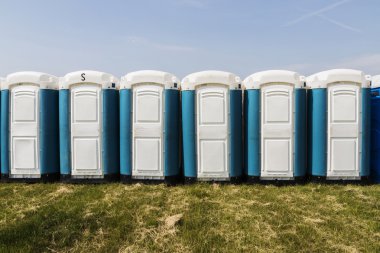 Long row of mobile toilets clipart