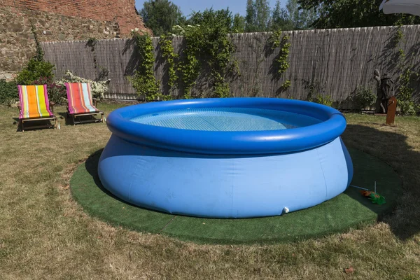 Blue rubber pool on the grass for children — Stock Photo, Image