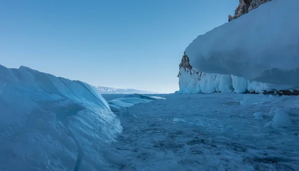 Frozen Lake Blue Shiny Ice Hummocks Icicles Frozen Rock Base — Stock Fotó