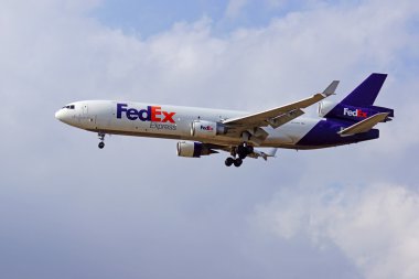 Jet FedEX airplane landing at Ontario International Airport outside of Los Angeles, California clipart