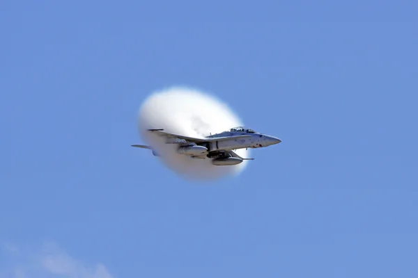 Airplane jet fighter F-18 Hornet in sonic boom at 2015 Miramar Air Show in San Diego, California