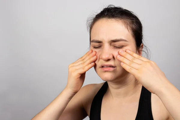 女性は顔に彼女の手を保持しています-副鼻腔炎の痛み,副鼻腔炎の痛みと副鼻腔炎,関節炎,頭痛.コピースペーステキストの場所で. — ストック写真