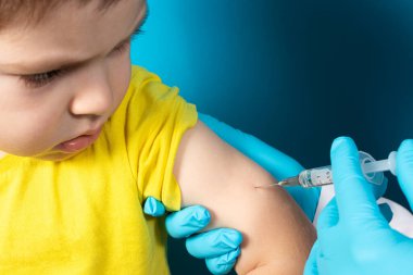 The doctor or nurse injects the child in the arm' in the shoulder. The concept of vaccination in health and medicine, vaccines for children. BCJ tuberculosis vaccination clipart