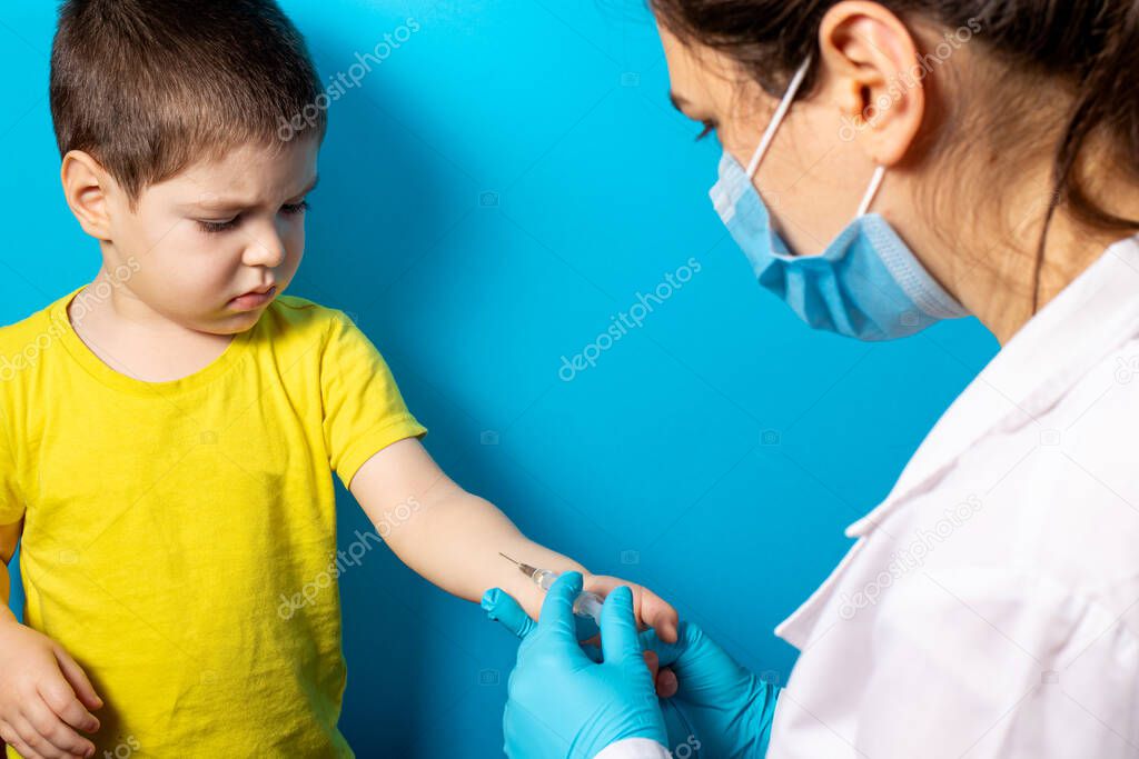 A doctor or nurse does a Mantoux test for a small baby boy. Tuberculosis test, vaccination. Intradermal tuberculin injection.