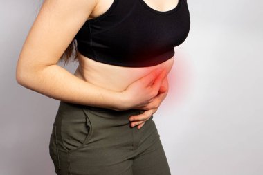 A womans stomach hurts. Abdominal pain due to gastritis, stomach ulcers and Crohns disease. Diseases of the gastrointestinal tract. Gastroenteritis, diarrhea or constipation. Nausea and vomiting clipart