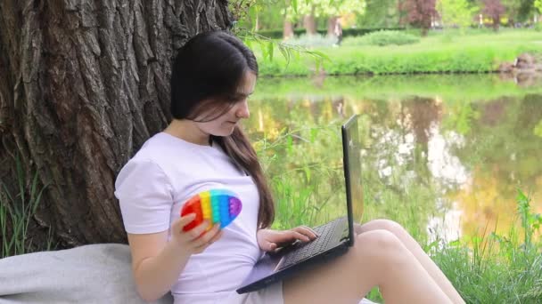 Woman Freelancer Student Works Laptop Nature Pops Reusable Bubble Wrap — Stock Video