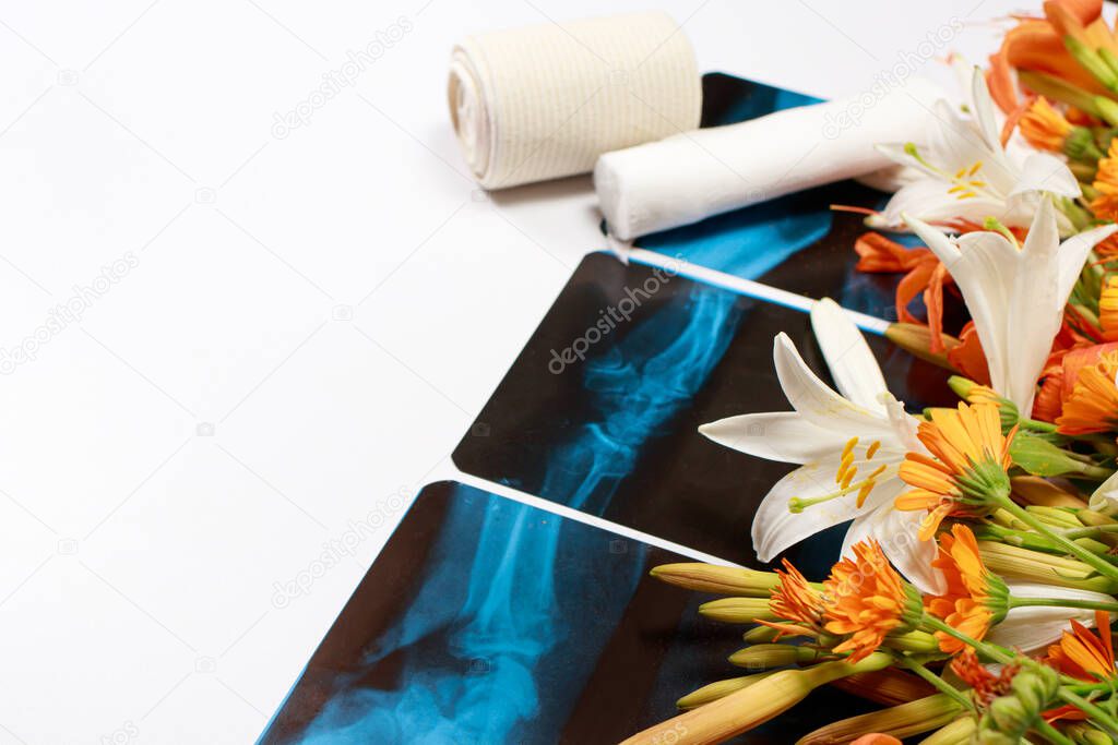 Greeting card with flowers and X-rays for the day of the traumatologist, radiologist, osteopath with a place for text on a white background
