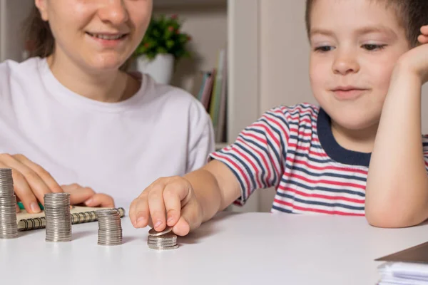 Ebeveyn çocuğa parayı nasıl idare edeceğini öğretir. Okul öncesi ve okul çağındaki çocuklar için mali okur yazarlık kursu.