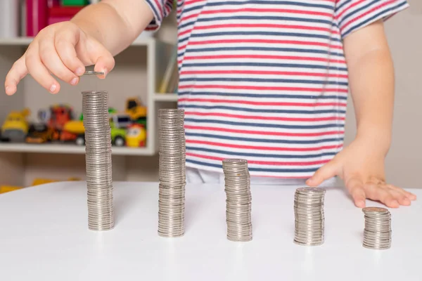 Child and coins - financial literacy for children, learning to spend money