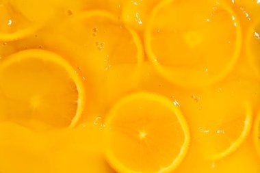 Meyve suyuyla kaplı portakal dilimlerinin soyut arkaplanı