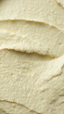 Yumuşak kremalı humus üst görünümünün makro dokusu.