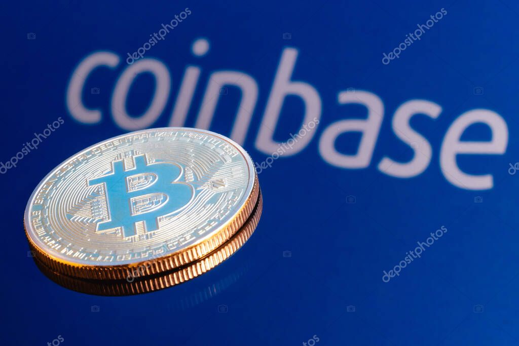 Kazan, Russia - May 16, 2021: Coinbase, is an American company that operates a cryptocurrency exchange platform. Bitcoin on the background of the coinbase inscription.