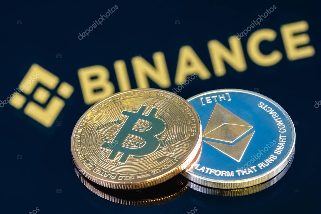 Kazan, Russia - May 17, 2021: Binance is cryptocurrency exchange that provides a platform for trading various cryptocurrencies. Ethereum coin and Bitcoin on the background of the BINANCE inscription.