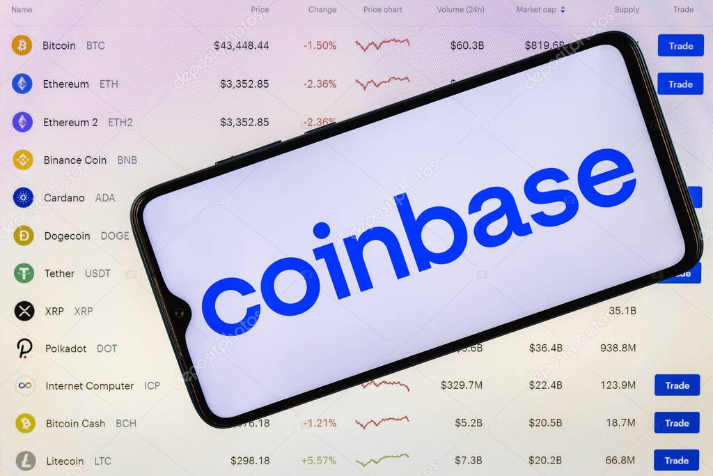 Kazan, Russia - May 18, 2021: Coinbase, is an American company that operates a cryptocurrency exchange platform. Coinbase logo on the background of the list of cryptocurrencies traded on the exchange.