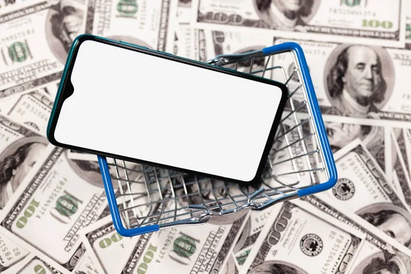 Mockup image of a smartphone with the blank white screen in food basket on the background of dollar bills.