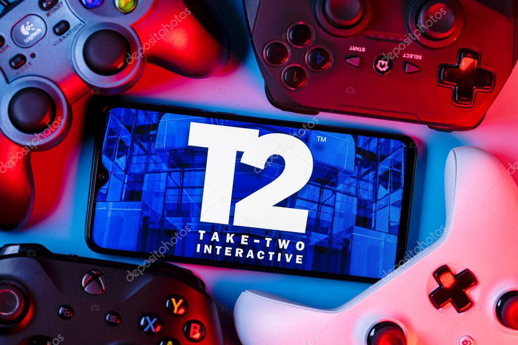 Kazan, Russia - August 19, 2021:  Take-Two Interactive Software, Inc. is an American video game holding company. A smartphone with the Take-Two logo on the screen surrounded by gamepads.