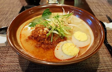 view of plate of ramen with chorizo, boiled egg and vegetables