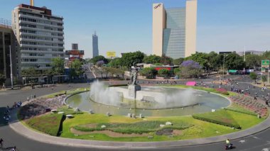 Aerial drone footage advancing near Minerva statue at iconic Guadalajara roundabout with fountains