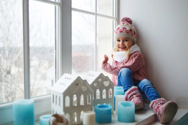 Sitting on a window sill — Stock Photo, Image