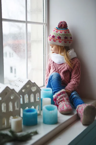 Oturma pencere pervazına ve sokak bakar