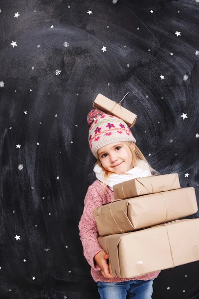 Little girl holding gifts — Stock Photo, Image