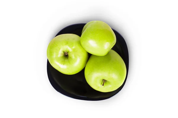 Three green apples on a black plate — Stock Photo, Image