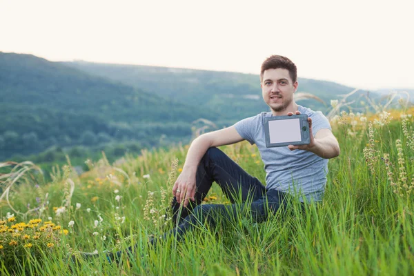 Man holding front of him an eBook with a white screen. — Stock Photo, Image