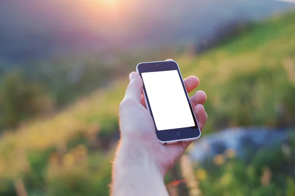 Men's left hand is holding a phone — Stock Photo, Image