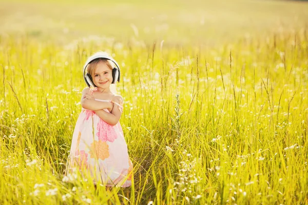 Rolig liten flicka med hörlurar — Stockfoto