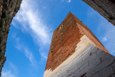 Montecchio Maggiore 'daki Romeo ve Juliet Vicenza kalelerinden birinin ortaçağ kulesinin görkemli perspektifi. Tepede bulutlar olan mavi gökyüzü Montecchio Maggiore. veneto Italy.
