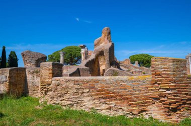 Rome Ostia Antica, architectural structures in bricks in the archaeological park of Ostia in summer with blue sky. Imperial era the port of Rome along the mouth of the Tiber.