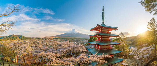 Mountain Fuji and Chureito red pagoda with cherry blossom sakura at sunset