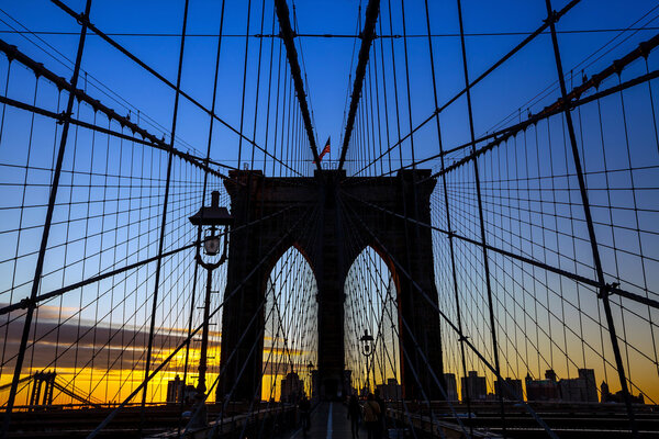 Tower of Brooklyn bridge New York city at sunset