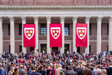 Students of Harvard University gather for their graduation cerem clipart