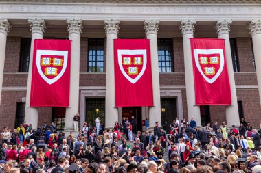 Students of Harvard University gather for their graduation cerem clipart