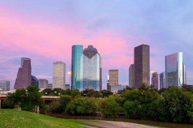 Houston Texas  skyline at sunset twilight from park lawn clipart