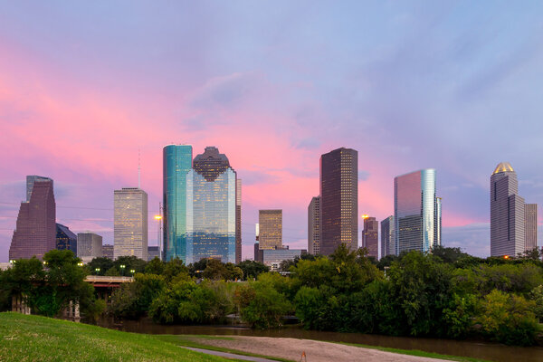 Houston Texas  skyline at sunset twilight from park lawn