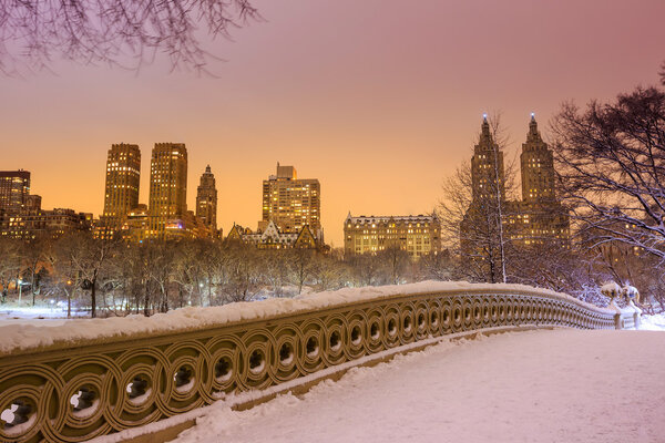 Central Park - New York City bow bridge after snow storm Linus at twilight