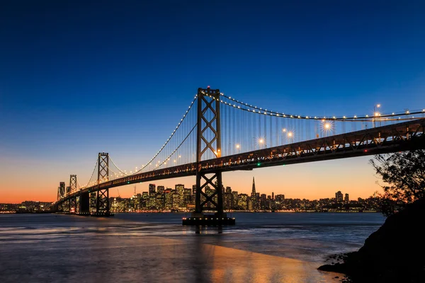 Most panoramę miasta i zatoki San francisco na zachodzie słońca, california — Zdjęcie stockowe