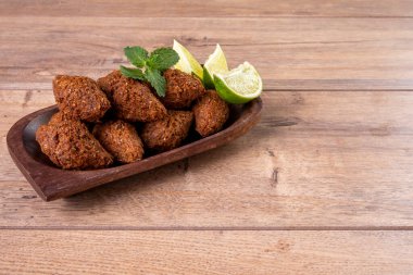 Traditional Arabian fried snack made with wheat and stuffed with minced meat. Quibe. clipart