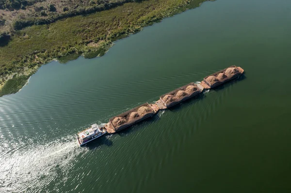 barge transporting commodities in river - Tiete Waterway.