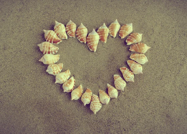 Heart made of shells on sand — Stock Photo, Image