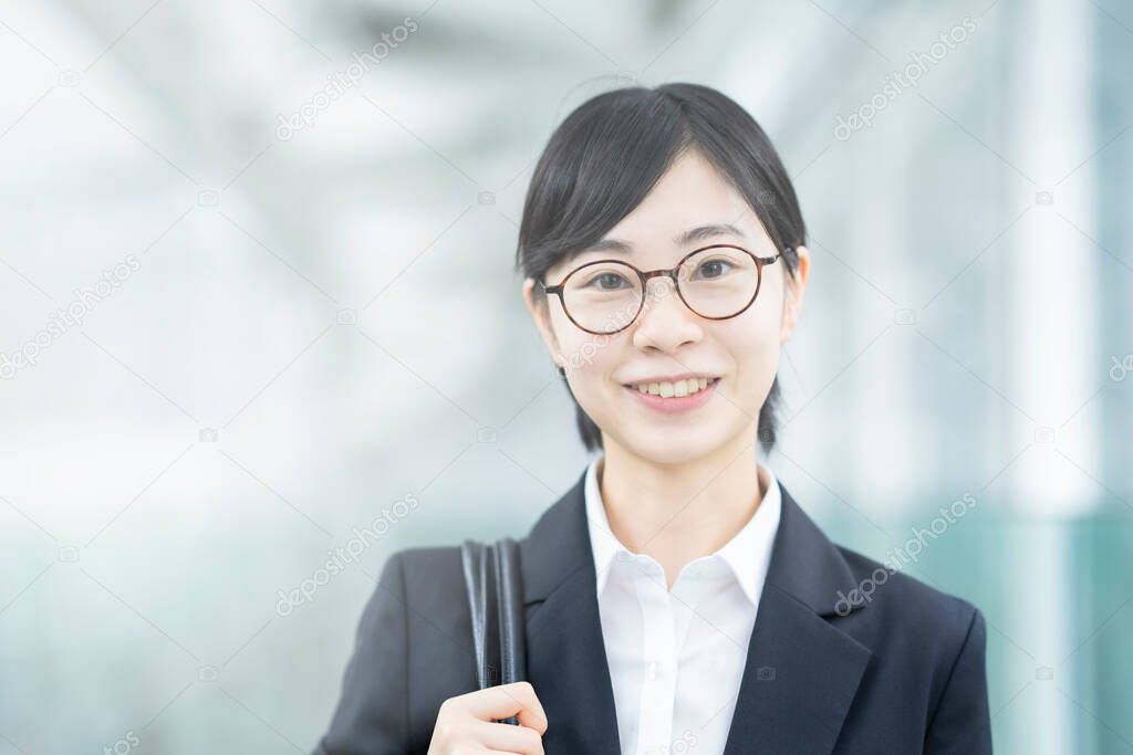 Asian young woman in a suit and glasses with smile