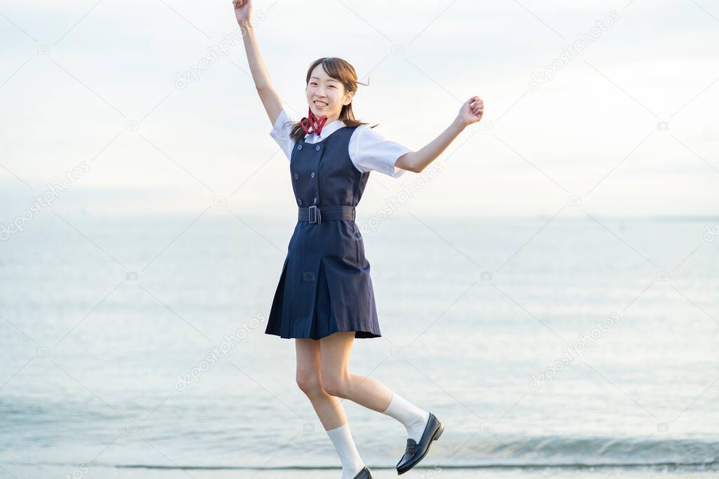 Asian female high school student in a cheering pose