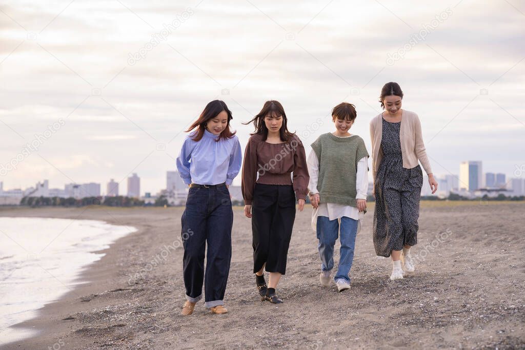 Four asian young women talking happily in the dusk