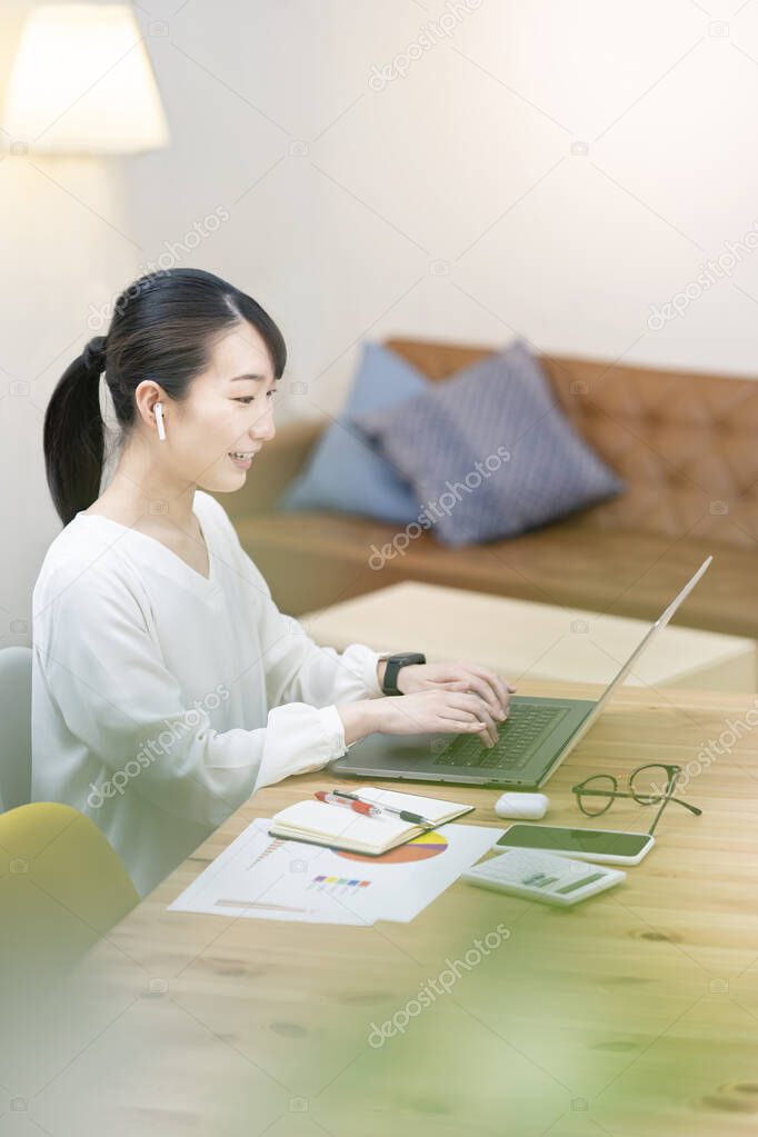 Asian young woman talking to a computer screen