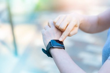 Orta yaşlı Asyalı bir kadın dışarıda akıllı bir hareket yapıyor.