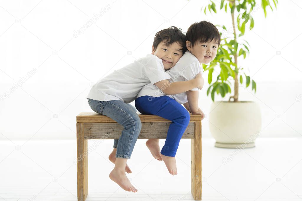 child sitting on a chair and frolicking with smile
