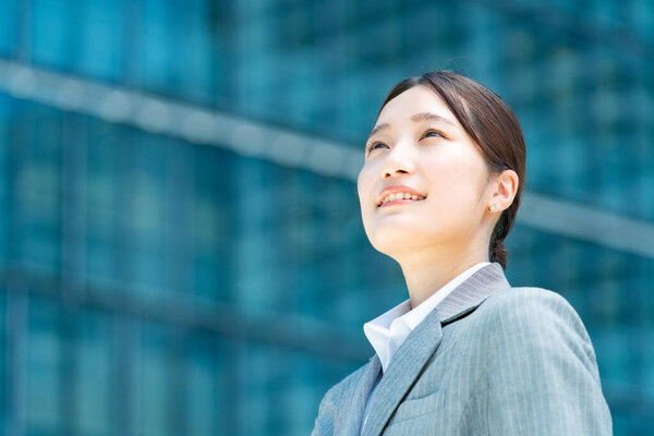 Portrait of young asian business woman in an office district