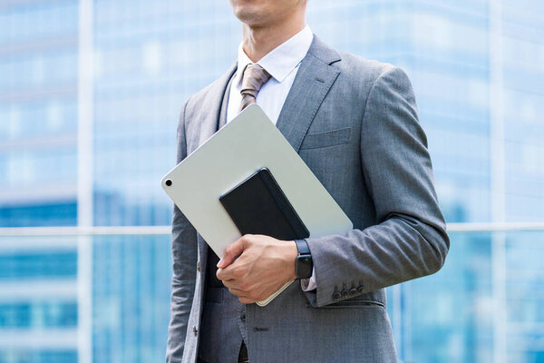 Anonymous image of a businessman standing outdoors